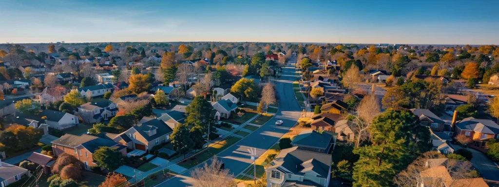 a focused aerial shot of a bustling raleigh neighborhood featuring freshly installed roofs, showcasing the professionalism and compliance of local roofing contractors under a clear blue sky.