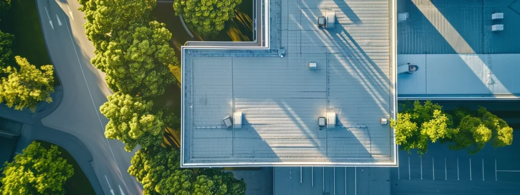 a striking aerial view captures a modern commercial building topped with vibrant single-ply membrane roofing, showcasing its sleek lines and energy-efficient design amidst a clear blue sky.